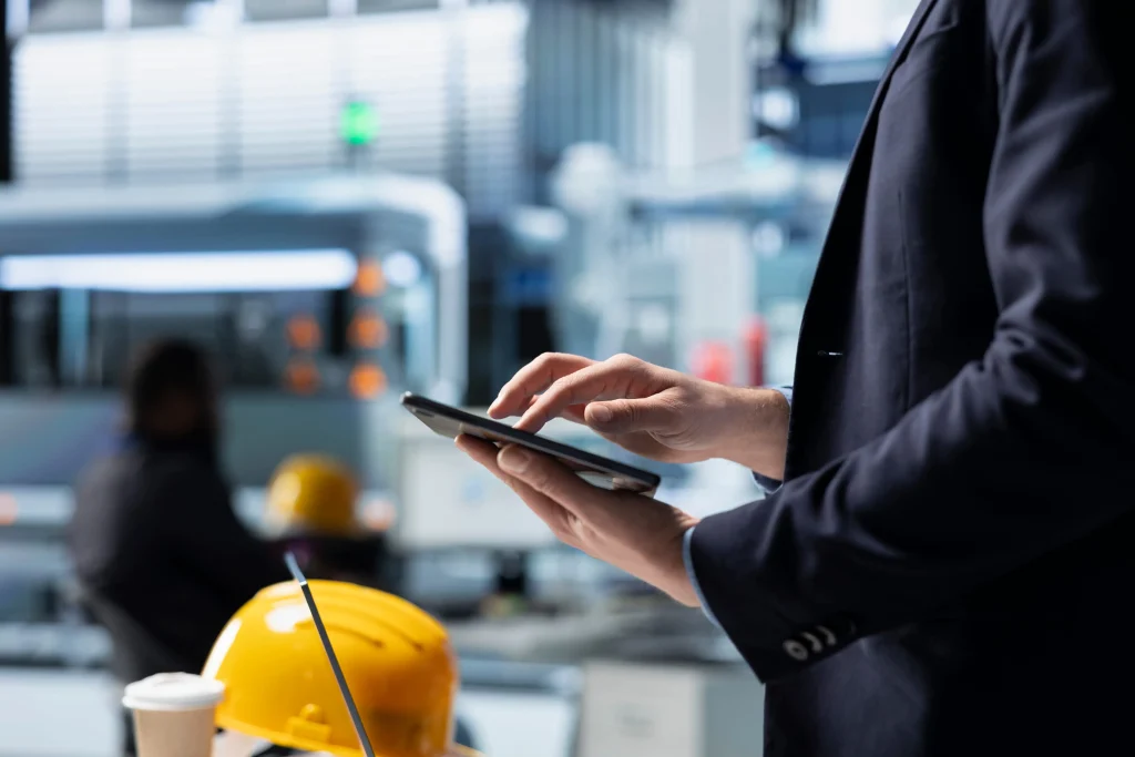 IoT sensors monitoring construction equipment performance on a smart construction site with real-time data dashboard.