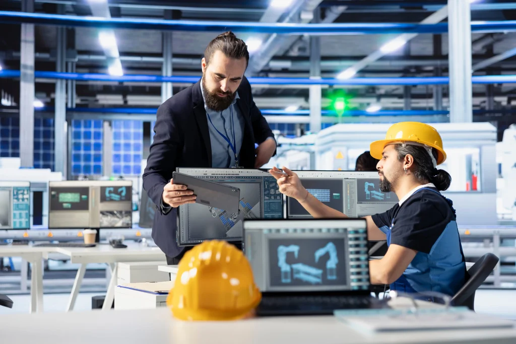 Mechanical engineer using modern engineering software on a computer to design and simulate components.